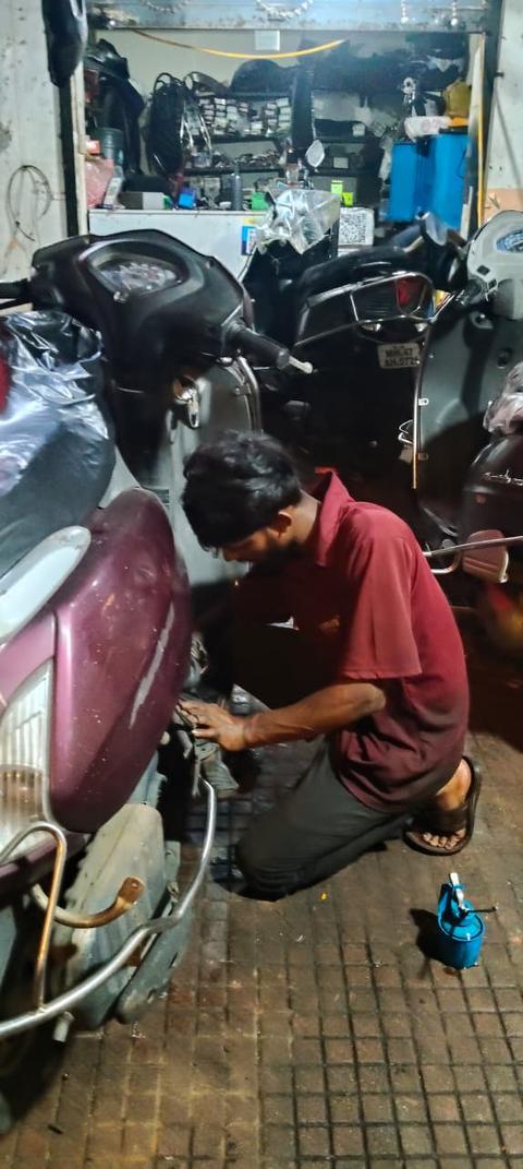 Mechanic servicing a scooty at Raj Auto Services, Charkop
